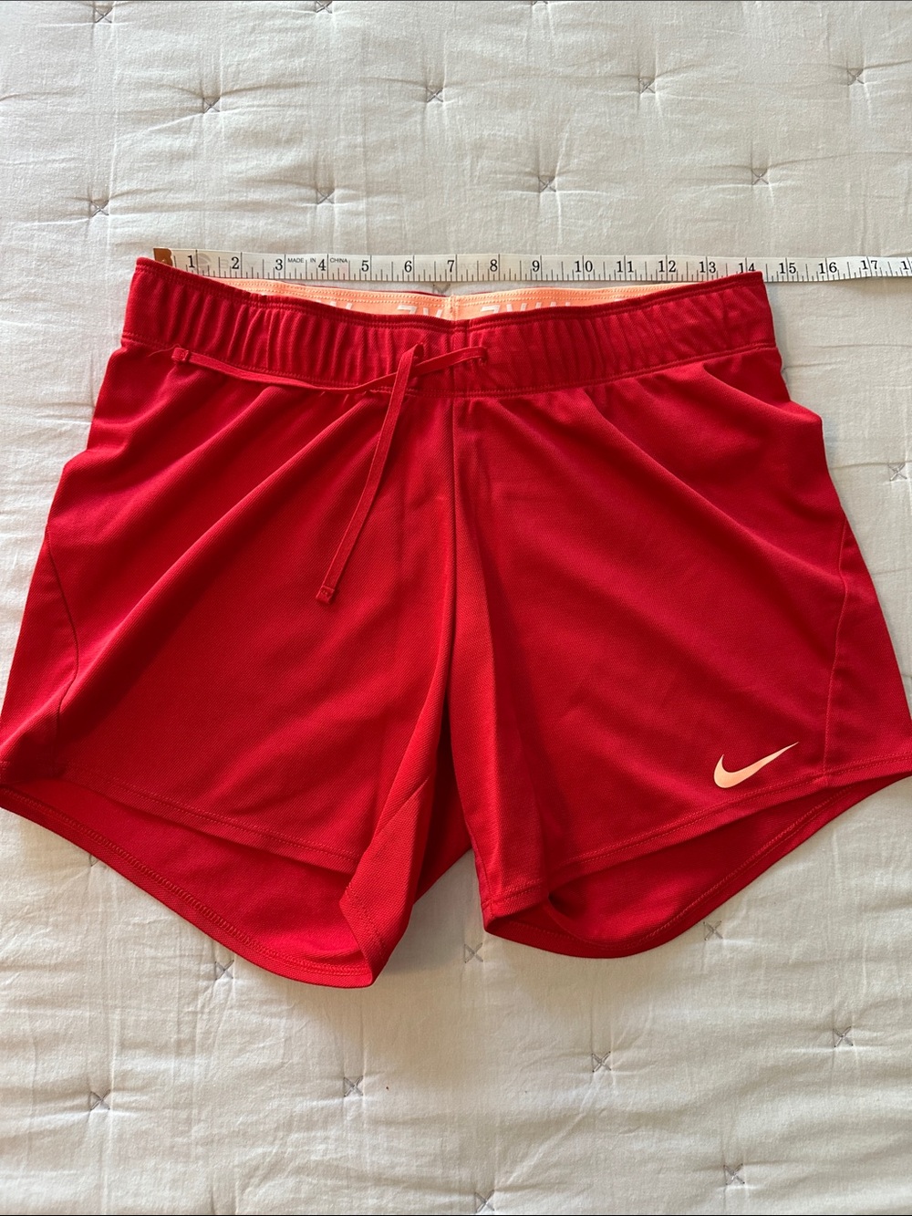 Nike Red Women's Athletic Running Shorts with peach Swoosh